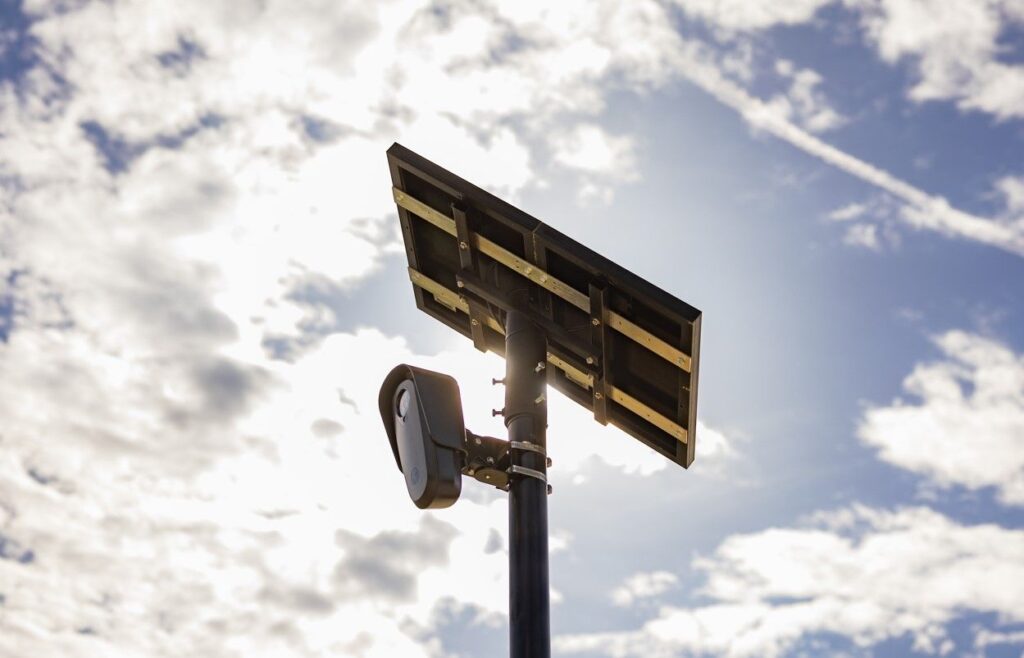 Picture of a Flock Safety LPR camera on a pole