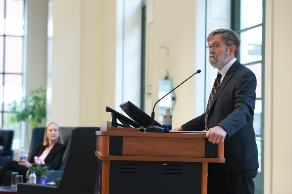 Edwin Kneedler at a podium